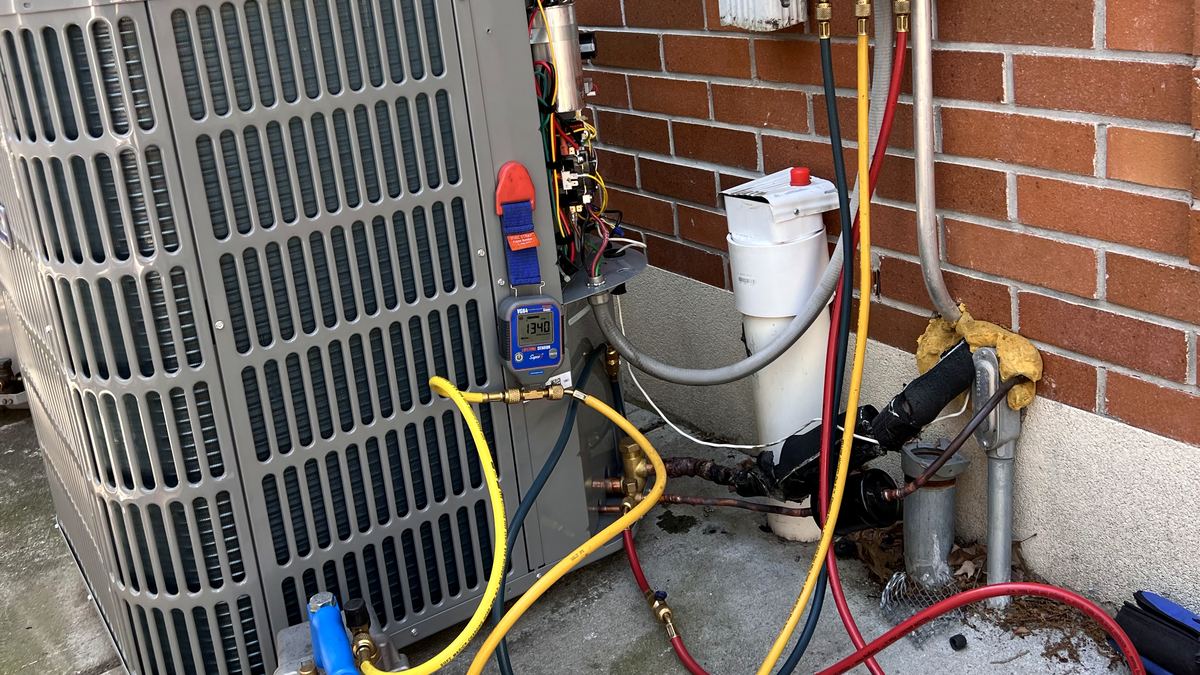 Refrigerant pressure testing on an outdoor central air conditioning unit